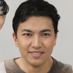 Joyful asian young-adult male with short  brown hair and brown eyes