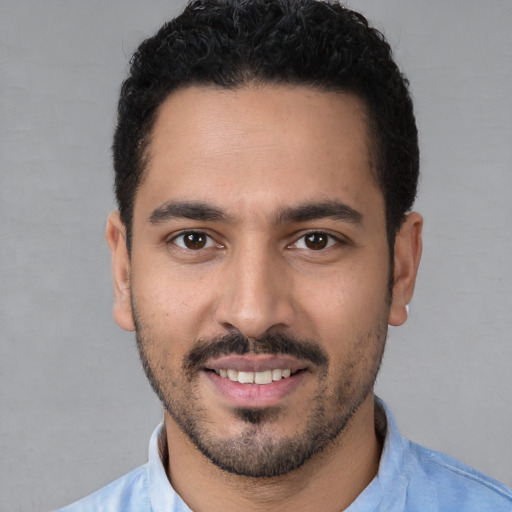 Joyful white young-adult male with short  black hair and brown eyes