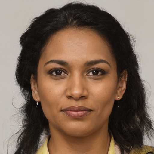 Joyful black young-adult female with medium  brown hair and brown eyes