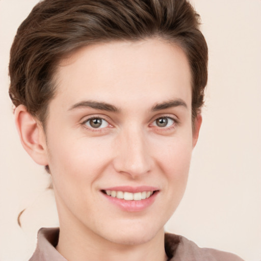 Joyful white young-adult female with short  brown hair and grey eyes