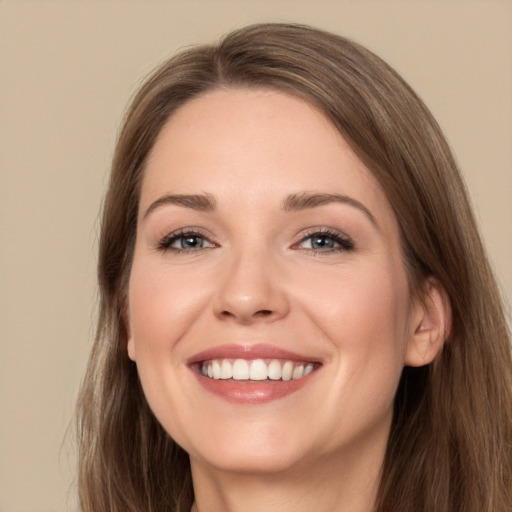 Joyful white young-adult female with long  brown hair and grey eyes