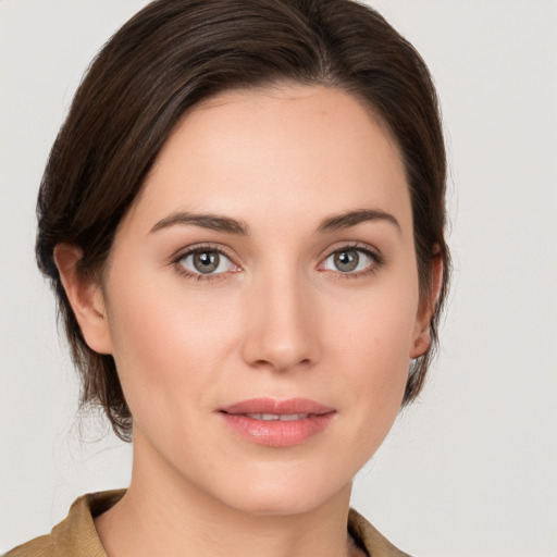 Joyful white young-adult female with medium  brown hair and grey eyes