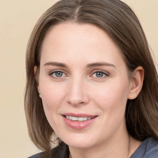 Joyful white young-adult female with long  brown hair and grey eyes