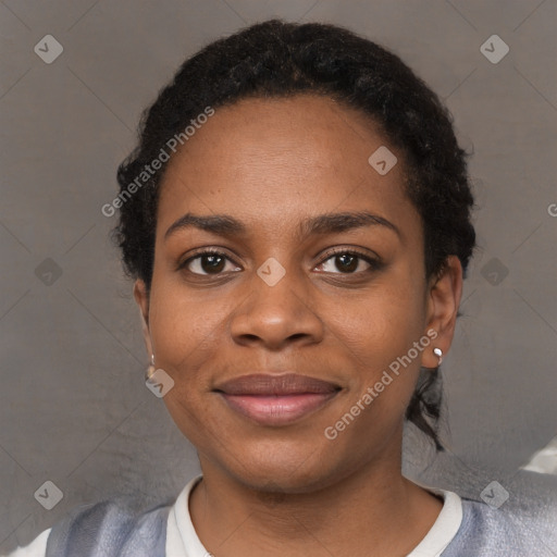 Joyful black young-adult female with short  black hair and brown eyes