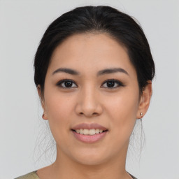 Joyful asian young-adult female with medium  brown hair and brown eyes