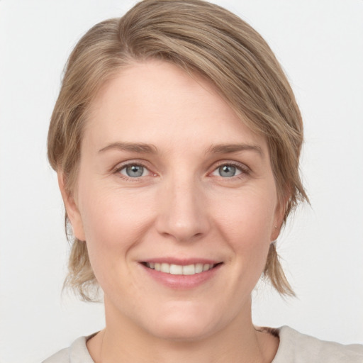 Joyful white young-adult female with medium  brown hair and blue eyes