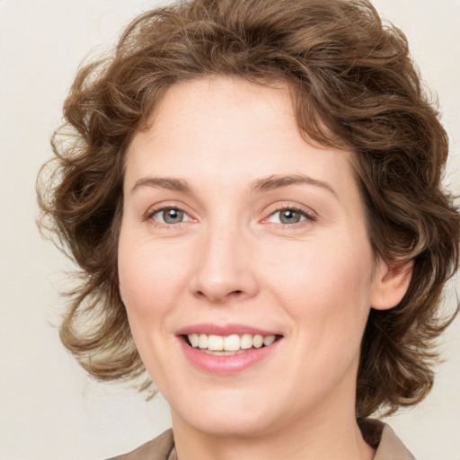 Joyful white young-adult female with medium  brown hair and green eyes