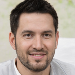 Joyful white young-adult male with short  brown hair and brown eyes