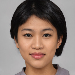 Joyful asian young-adult female with short  black hair and brown eyes