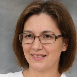 Joyful white adult female with medium  brown hair and brown eyes