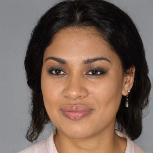 Joyful black young-adult female with medium  brown hair and brown eyes