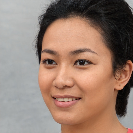 Joyful asian young-adult female with medium  brown hair and brown eyes