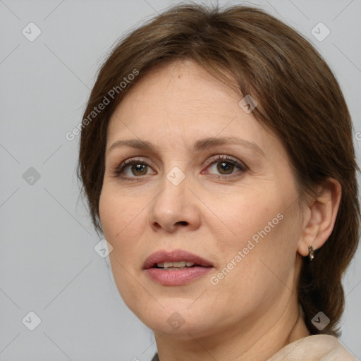 Joyful white adult female with medium  brown hair and grey eyes