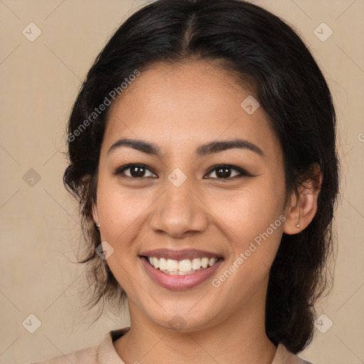 Joyful latino young-adult female with medium  brown hair and brown eyes