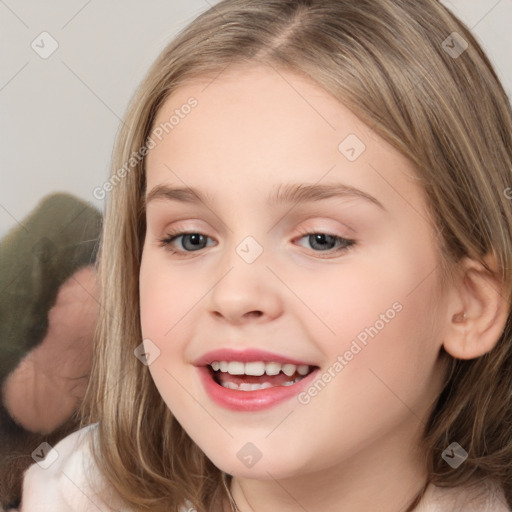 Joyful white child female with medium  brown hair and brown eyes