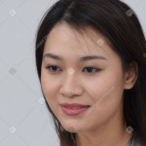 Joyful asian young-adult female with long  brown hair and brown eyes