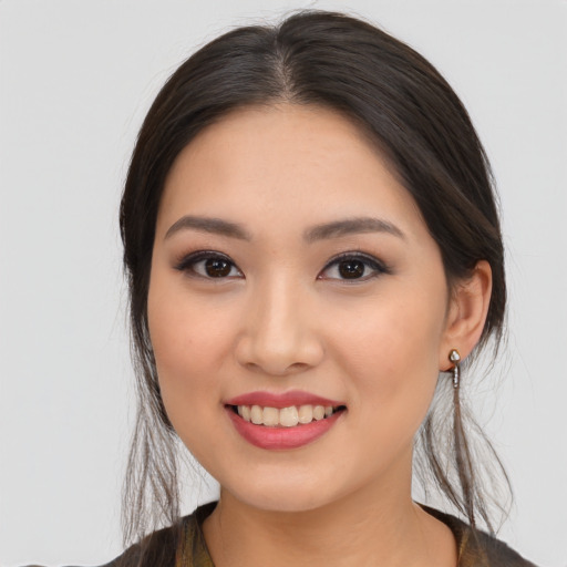 Joyful asian young-adult female with medium  brown hair and brown eyes