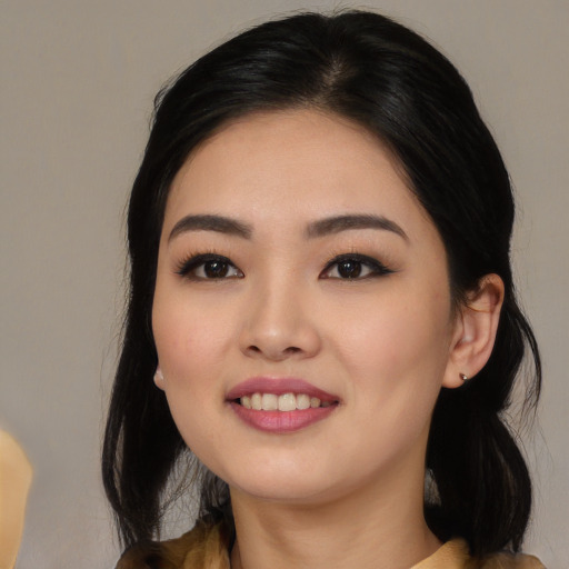 Joyful asian young-adult female with long  black hair and brown eyes