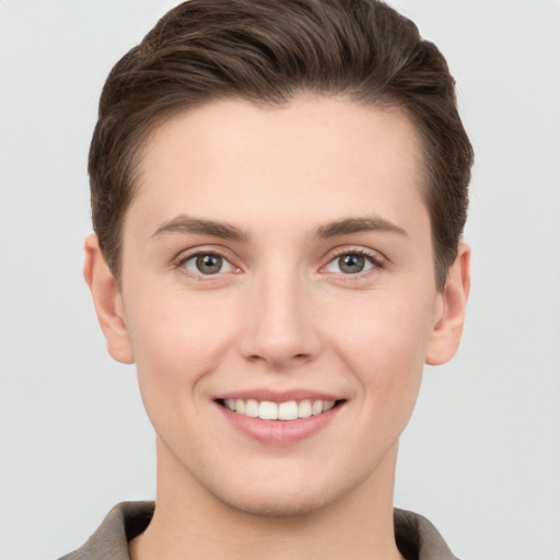 Joyful white young-adult female with short  brown hair and brown eyes