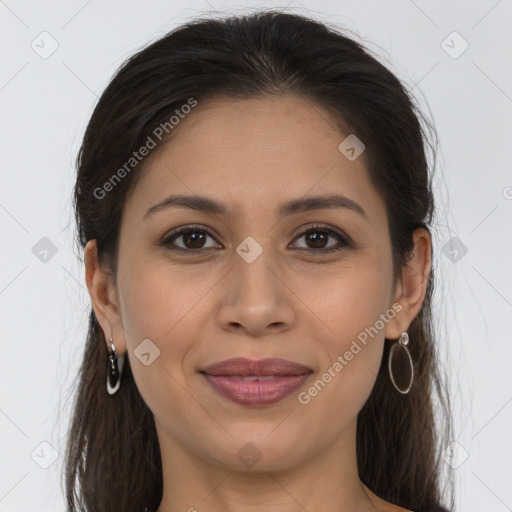 Joyful latino young-adult female with long  brown hair and brown eyes