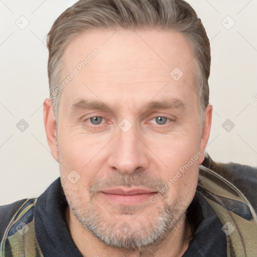 Joyful white adult male with short  brown hair and grey eyes