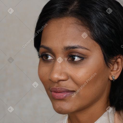 Joyful black young-adult female with medium  black hair and brown eyes