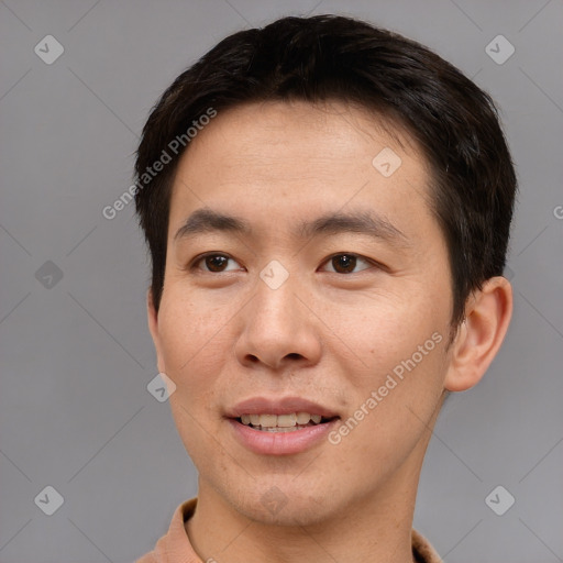 Joyful asian young-adult male with short  brown hair and brown eyes