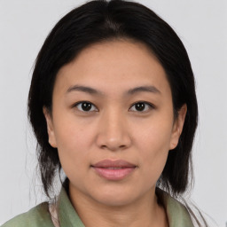 Joyful asian young-adult female with medium  black hair and brown eyes