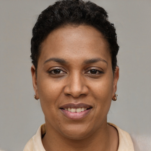 Joyful black young-adult female with short  brown hair and brown eyes