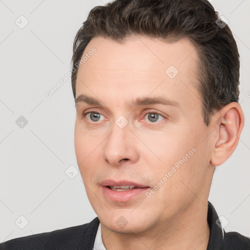 Joyful white adult male with short  brown hair and brown eyes