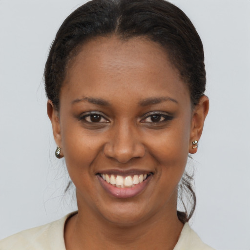 Joyful black young-adult female with short  brown hair and brown eyes