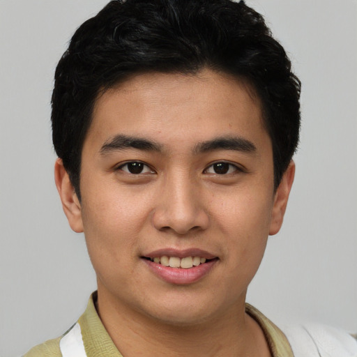 Joyful asian young-adult male with short  black hair and brown eyes