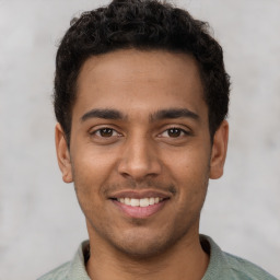 Joyful latino young-adult male with short  brown hair and brown eyes