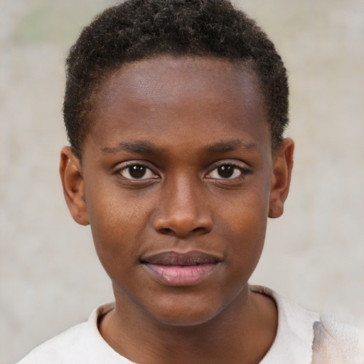 Joyful black child male with short  brown hair and brown eyes