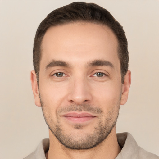 Joyful white young-adult male with short  brown hair and brown eyes