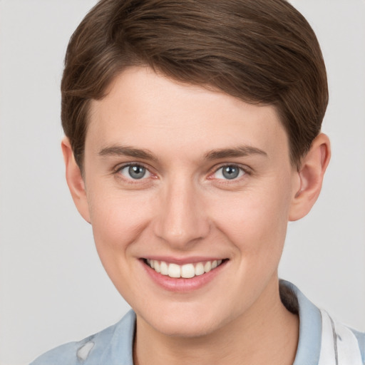 Joyful white young-adult female with short  brown hair and grey eyes