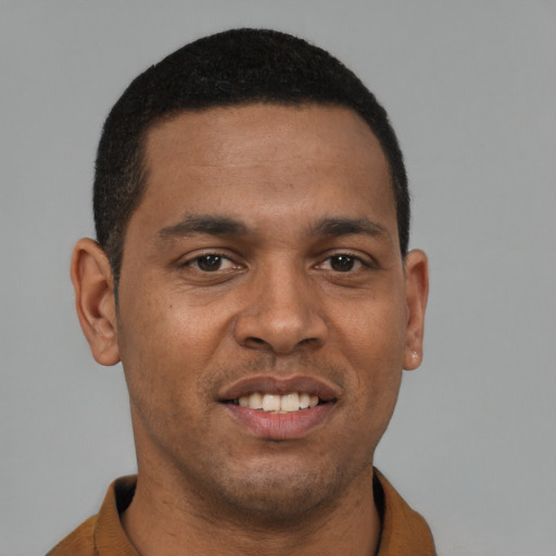 Joyful latino young-adult male with short  brown hair and brown eyes