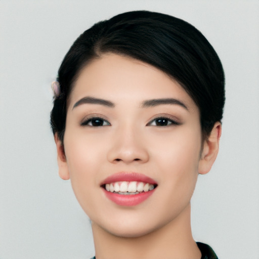 Joyful asian young-adult female with short  black hair and brown eyes