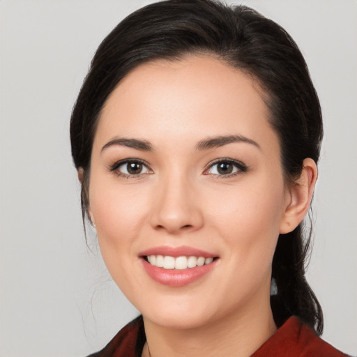 Joyful white young-adult female with medium  black hair and brown eyes