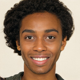 Joyful black young-adult male with short  brown hair and brown eyes