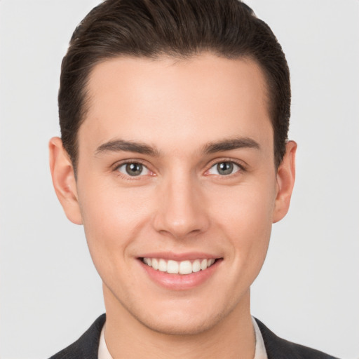 Joyful white young-adult male with short  brown hair and brown eyes