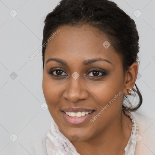 Joyful black young-adult female with short  brown hair and brown eyes