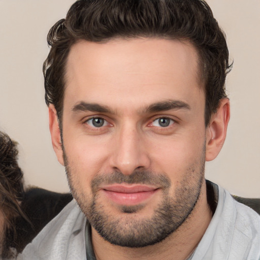 Joyful white young-adult male with short  brown hair and brown eyes