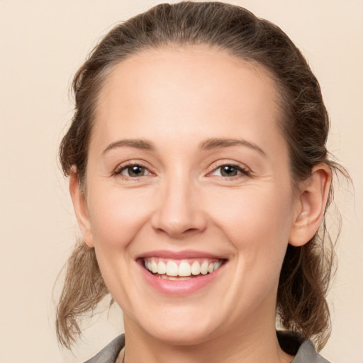 Joyful white young-adult female with medium  brown hair and brown eyes