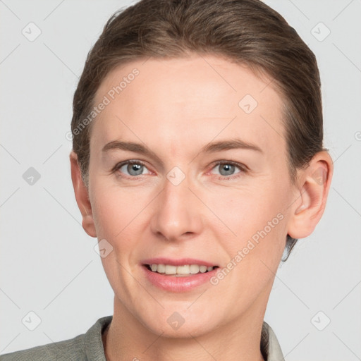 Joyful white young-adult female with short  brown hair and grey eyes