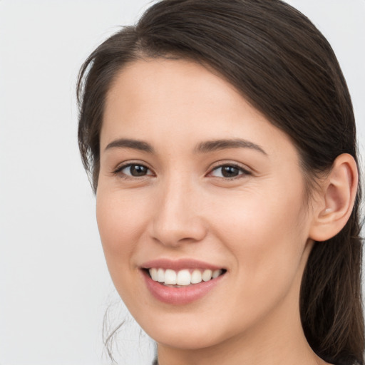 Joyful white young-adult female with long  brown hair and brown eyes