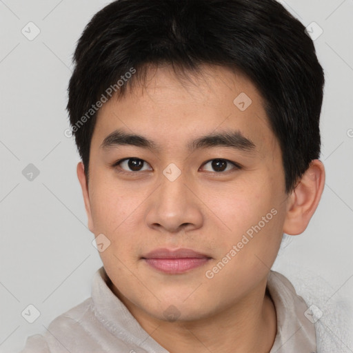 Joyful asian young-adult male with short  brown hair and brown eyes