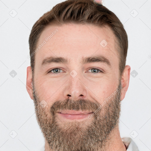 Joyful white adult male with short  brown hair and grey eyes