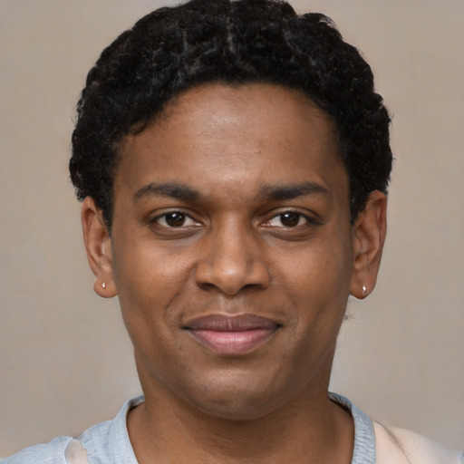Joyful latino young-adult male with short  brown hair and brown eyes
