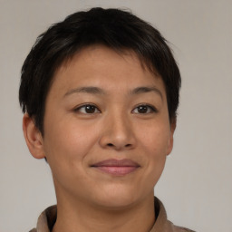 Joyful asian young-adult female with short  brown hair and brown eyes